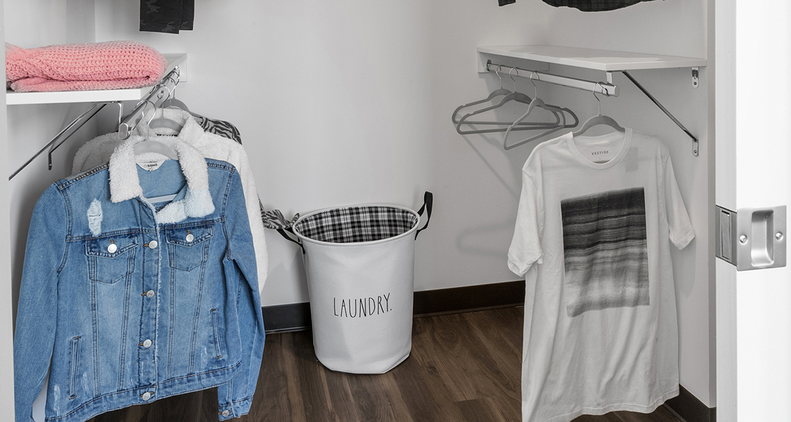 a closet with some clothing hanging