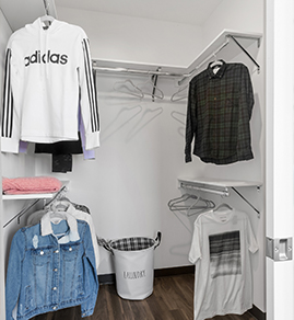 a closet with some clothing hanging